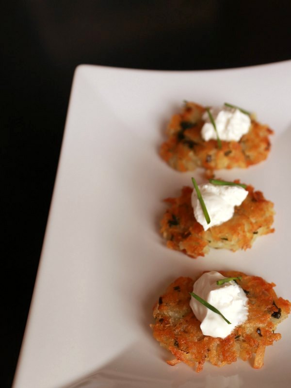 Golden Crisp Potato Latke served with sour cream. This recipe is easy to make and requires only one ingredient. No eggs, No browning, No draining!