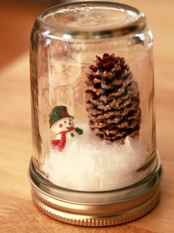 DIY Mason Jar Waterless Snow Globe as party favor for Winter Wonderland Birthday Party Theme.