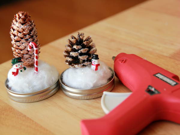 DIY Mason Jar Waterless Snow Globe as party favor for Winter Wonderland Birthday Party Theme.