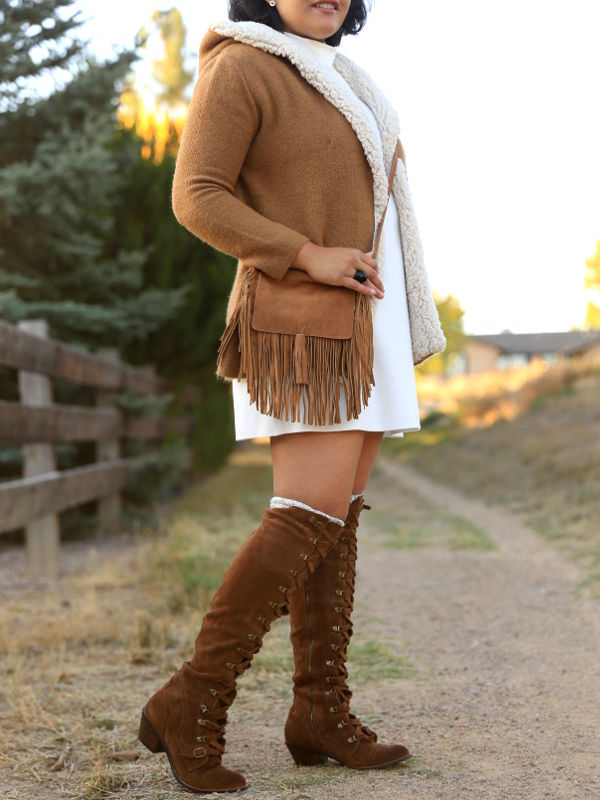 Get cozy in winter, with shades of white and tan. Pair the tan fleece lined coat and suede OTK boots with white mock neck dress. 