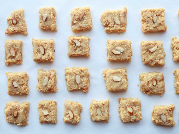 Divide into equal pieces and decorate with almond slices for Easy Til ki Barfi