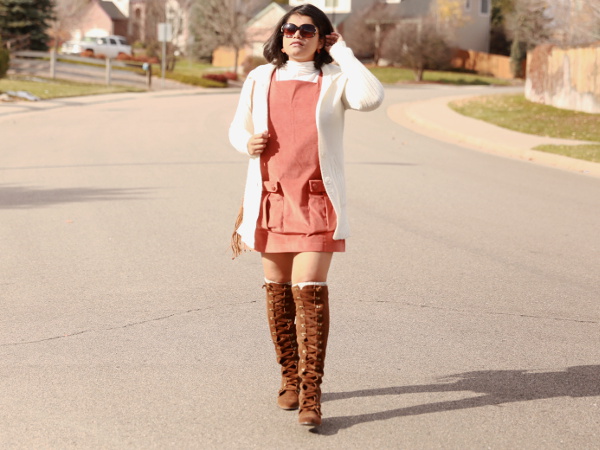 ASOS Orange Corduroy Overall Dress pairs well with a contrasting cream high neck t-shirt and cardigan.