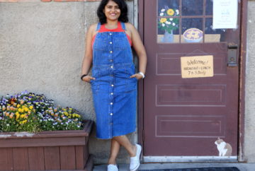 Wearing blue denim overall dress with red top and white sneakers for the 4th of July weekend in Whitefish.