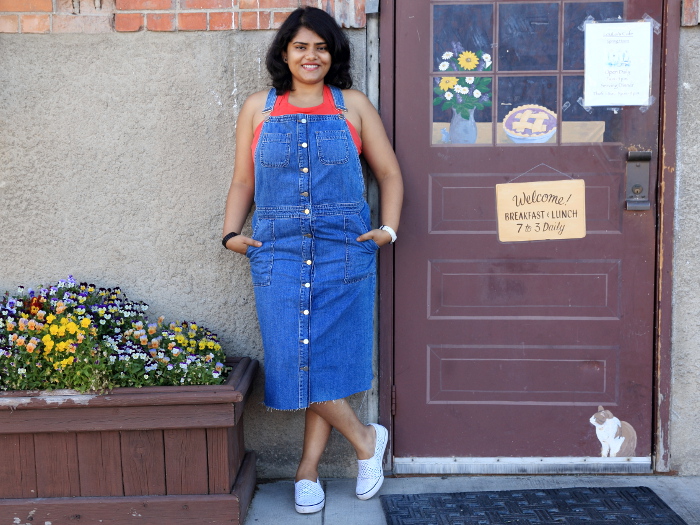 Wearing blue denim overall dress with red top and white sneakers for the 4th of July weekend in Whitefish.