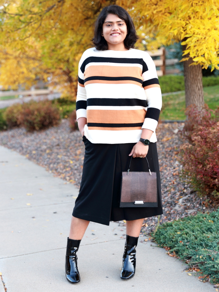 Striped sweater is a fall essential just like a striped tee is for summer. Wear it with a midi skirt and booties to create a formal office look.