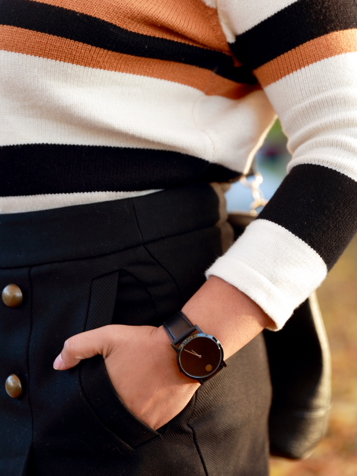 Striped sweater is a fall essential just like a striped tee is for summer. Pair it with a classic watch like Movado to create a chic look.